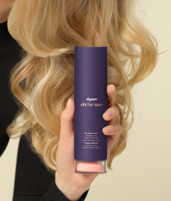 Bottle of Dyson Chitosan™ Post-style Serum, perfect for enhancing hair and reducing frizz